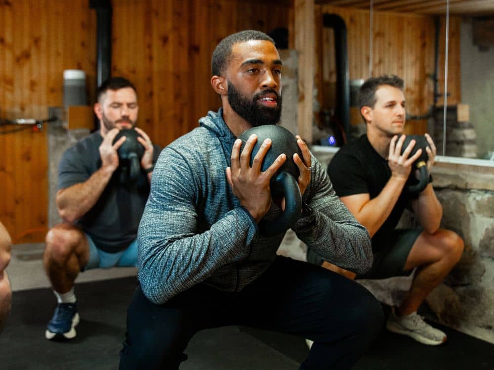 Coach Joshua Parris of Parris Performance Institute coaching members during a small group training class